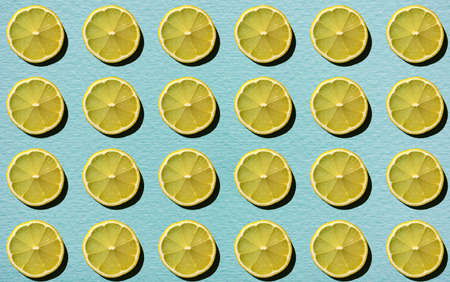Background from natural fruits. Yellow lemon on a blue background. Juicy pattern.の写真素材