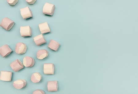 Sweet marshmallow lies on a blue background. Place for text.の写真素材