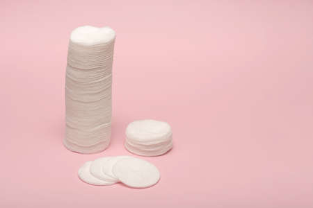 Cotton pads for removing makeup at home. On a pink background.の写真素材