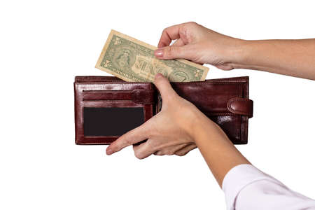 Hands put money in a brown wallet. On a white background.の写真素材