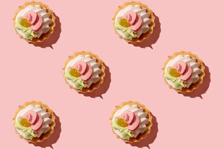 Cake. Delicious dessert on a pink background. Pattern for design. Colorful sweet cupcake.の写真素材