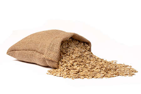 A full sack of oats lies on a white background. Close-up. Breakfast oatmeal.