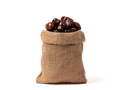 A bag of dates is a sweet dry dessert. Diet fruits on a white background. Close-up.の写真素材