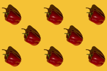 Pattern. Texture from red bell peppers. On a yellow background. Raw vegetable.の写真素材