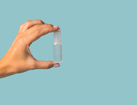 Plastic white container with medicine. Close-up on a blue background.の写真素材
