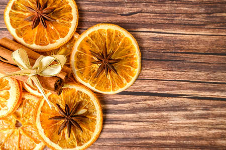 Dry orange oranges. Dried citrus fruits. Tropical fruit. Cinnamon sticks. On a brown background.の写真素材