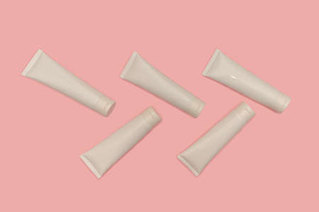 White container of cosmetic cream on a pink background.の写真素材