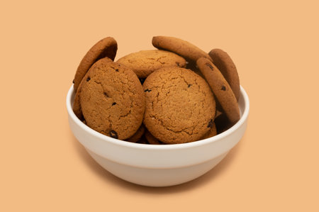 Oatmeal cookies in a white deep plate. diet food. On a beige background.の写真素材