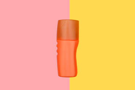 Orange plastic container. Skin cream. Protective cream.