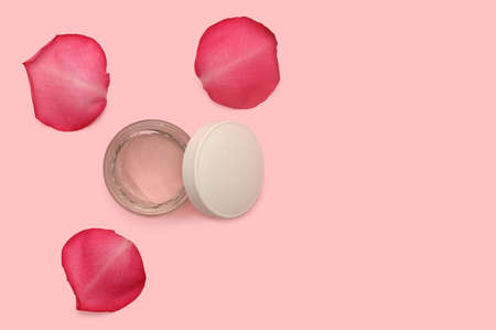White container for cosmetic cream. Rose petals.の写真素材