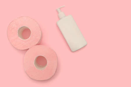 Pink toilet paper on a pink background and lotion. Health and hygiene every day. Place for text.の写真素材