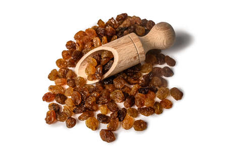 A bunch of raisins on a wooden scoop. Dried brown grapes. On a white background.の写真素材