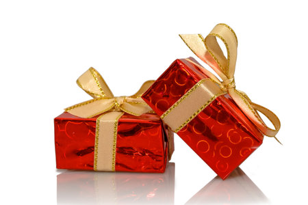 Two red gift boxes with a yellow bow. On a white background. close-up.