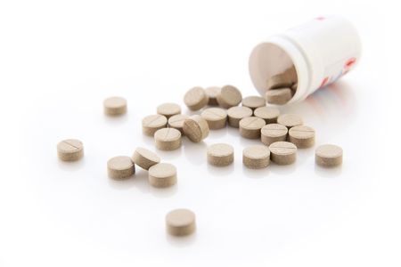 Herbal pills on the white background