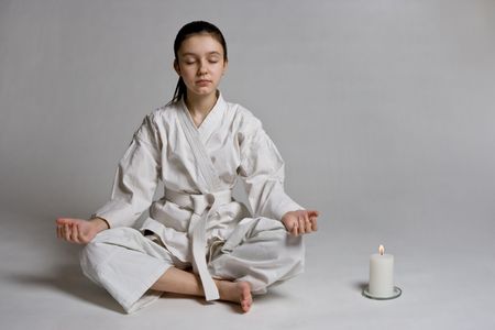 The girl in a sports kimono in a relaxation poseの写真素材