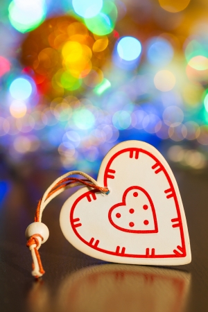 White wooden heart on Christmas garland lights backgroundの写真素材