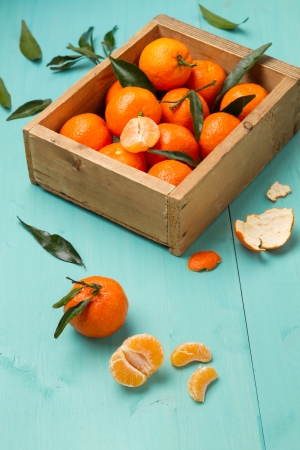 Box of tangerines on a turquoise kitchen tableの写真素材