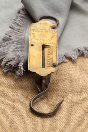 Old steelyard with rust on linen napkin and burlap