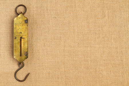 Ancient steelyard on hessian background (horizontal shot)の写真素材