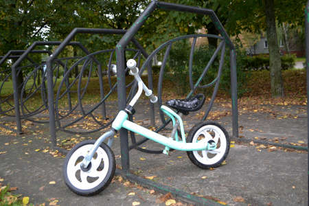 childrens bike in the autumn park in the bicycle parking lot. High quality photo