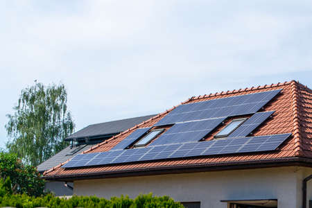 Historic farm house with modern solar panels on roof and wall High quality photo