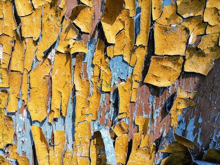 Abstration of the flag of Ukraine on a wall with a crack. A crisis. Dirty old yellow and blue wood...