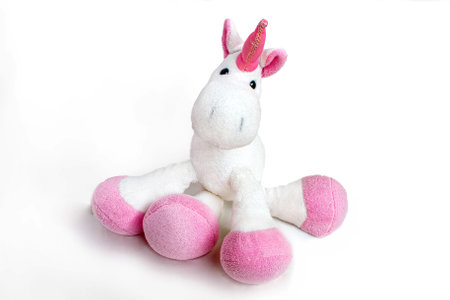 Lovely white pony doll isolated on white background. Adorable teddy bear for decorative. High quality photoの写真素材