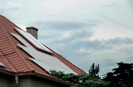 Installing a Solar Cell on a Roof. Solar panels on roof. Historic farm house with modern solar...