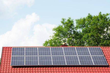 Installing a Solar Cell on a Roof. Solar panels on roof. Historic farm house with modern solar...