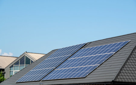 House roof with photovoltaic modules. Historic farm house with modern solar panels on roof and wall...