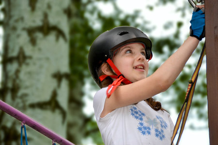 adventure climbing high wire park - people on course in mountain helmet and safety equipment. High quality photoの写真素材