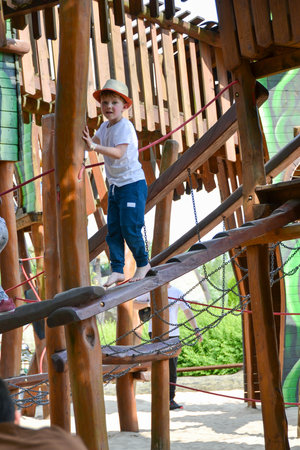 life of children in a modern city - little boy is having fun on the playground near the house. high quality photoの写真素材