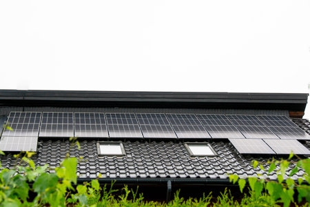 Historic farm house with modern solar panels on roof and wall Illustrationの写真素材