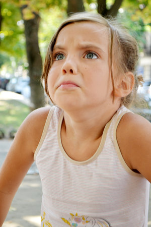 The girl goes in for sports on the Playground on the street. exercises, stretching, exercises....