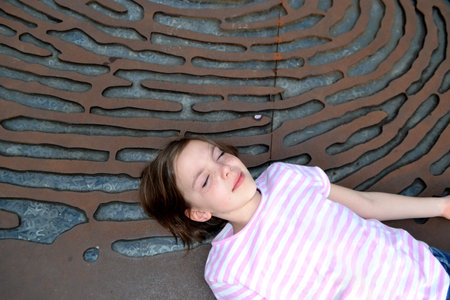 Cute kid girl 10 year old posing on nature background. Looking at camera. Childhood.Blonde girl emotions. High quality photoの写真素材