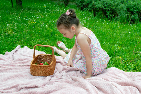 little cute children eating strawberries from a basket outdoors. High quality photo