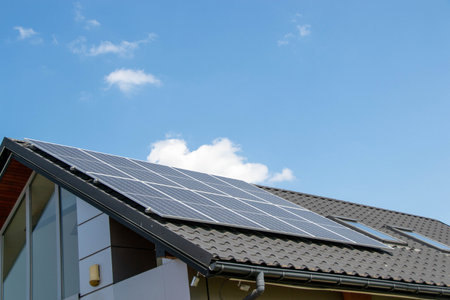 House roof with photovoltaic modules. Historic farm house with modern solar panels on roof and wall...