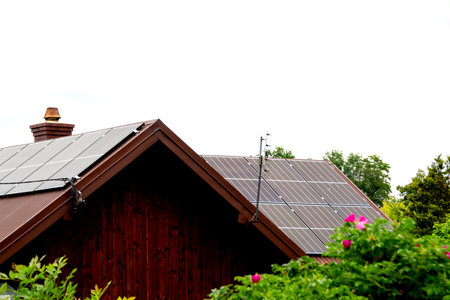 House roof with photovoltaic modules. Historic farm house with modern solar panels on roof and wall High quality photoの写真素材
