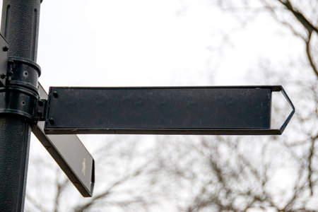 Sign pointers with inscriptions against the blue sky.Black directionl signs on a blue sky...