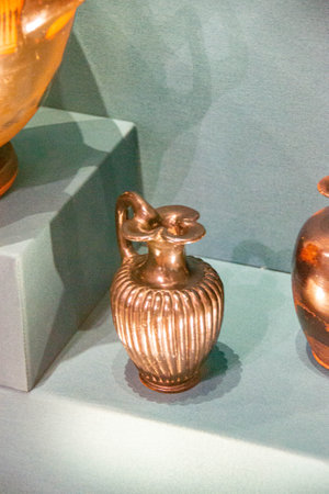 Antique ceramic decorative amphora on a white background. Clay jugs and a pot, a set of ancient utensils for drinking wine, water or milk. High quality photoの写真素材
