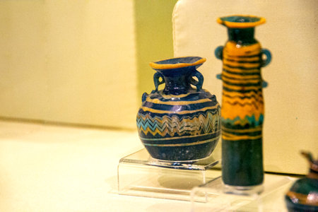 Antique ceramic decorative amphora on a white background. Clay jugs and a pot, a set of ancient utensils for drinking wine, water or milk. High quality photoの写真素材