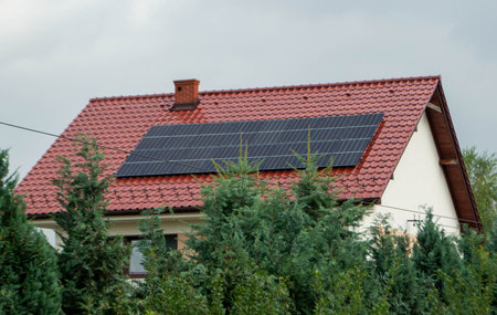 House roof with photovoltaic modules. Historic farm house with modern solar panels on roof and wall...