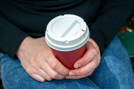 Couple clinking hot coffee cups. Set of women hands holding coffee paper drinking cup with...