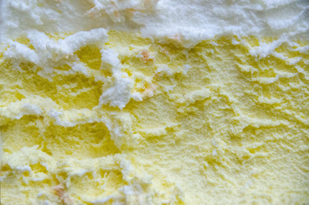 texture of yellow white and green ice cream like background, close up. Strawberry ice cream texture close up. Top view. Pink fruit ice cream background with small pieces of berries. High quality photoの写真素材