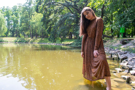 close up portrait of young and tender woman on a feild at sunset. High quality photoの写真素材