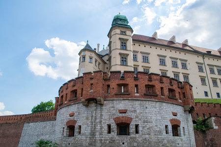 The view of the Wawel Royal Castle from the ground. Fortress wall, Wawel Danish tower, representative royal chambers. Ancient facade of the building Wawel Castle City of Krakow. High quality photoの写真素材