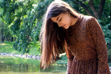 close up portrait of young and tender woman on a feild at sunset. High quality photoの写真素材