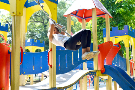 adventure climbing high wire park - people on course in mountain helmet and safety equipment. High...