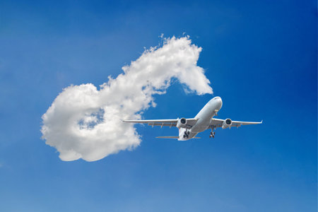 White passenger airplane flying in the sky amazing clouds in the background - Travel by air transport. High quality photoの写真素材