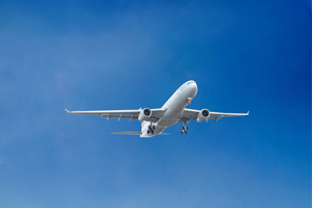 White passenger airplane flying in the sky amazing clouds in the background - Travel by air...